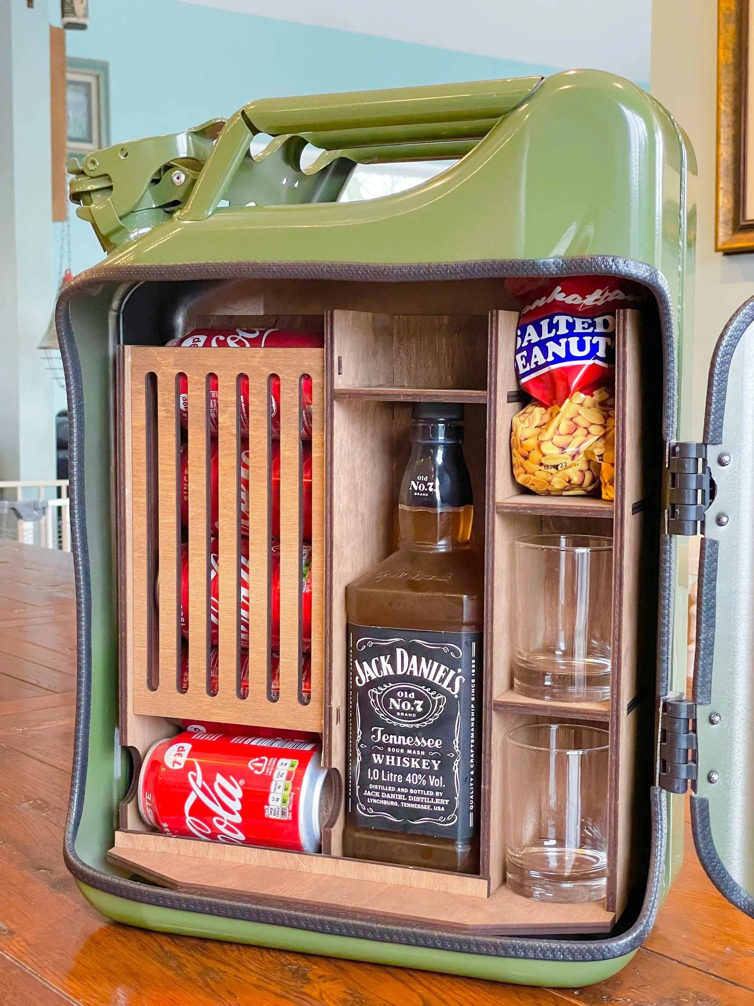 Open green jerry can mini bar cabinet with bottle cans glasses and wood interior shelves